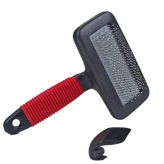 Pet grooming brush with red handle and black bristles on a white background