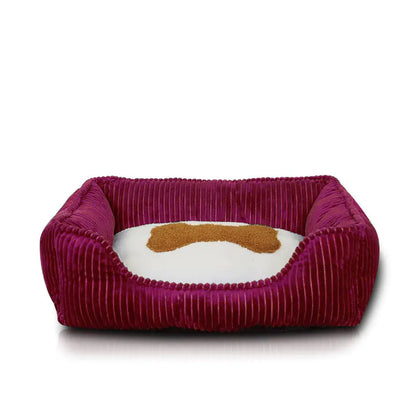 Maroon pet bed with a white cushion and brown bone design on a white background