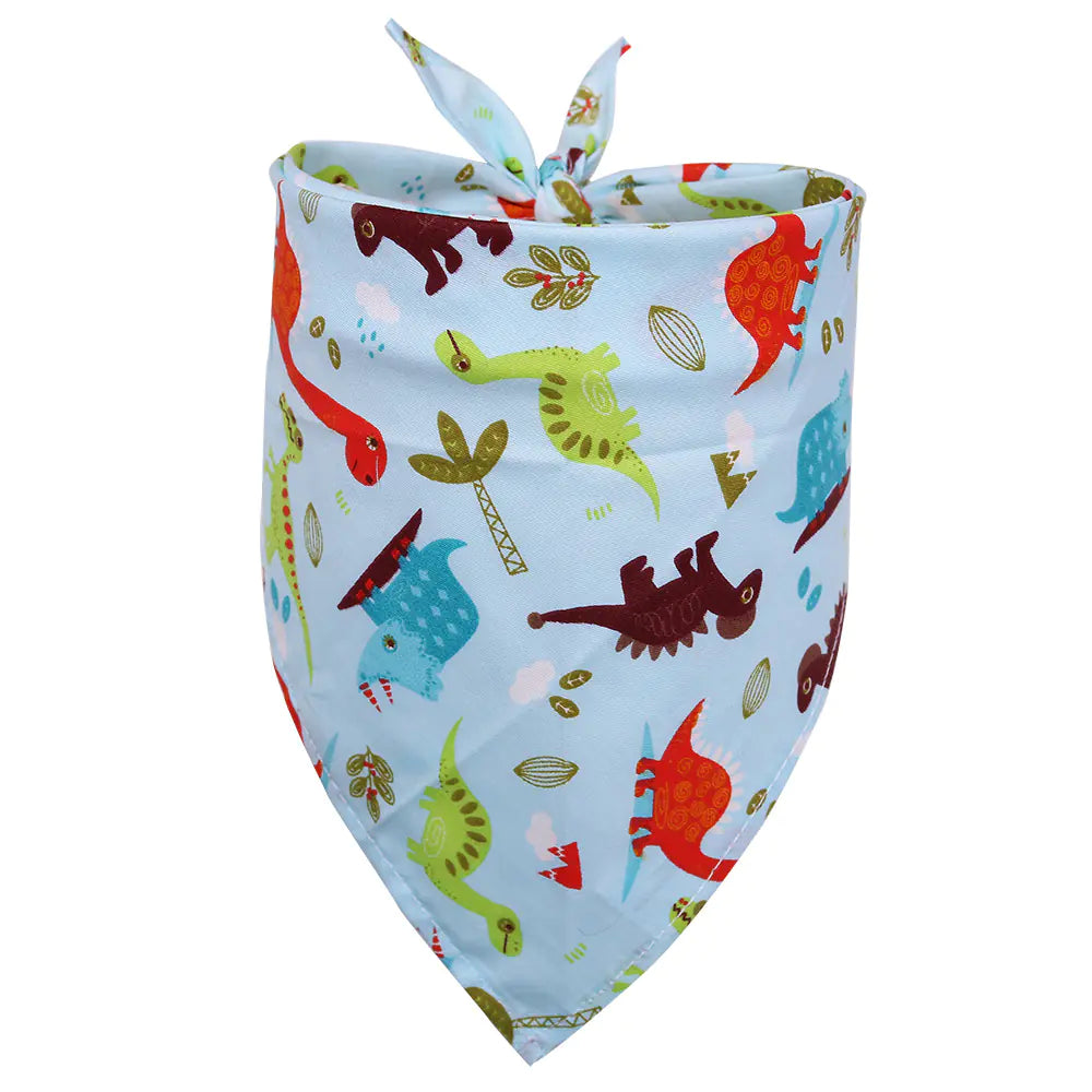 Baby bib with colorful dinosaur pattern on a light blue background