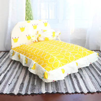 Yellow cushion with a pattern on a striped rug