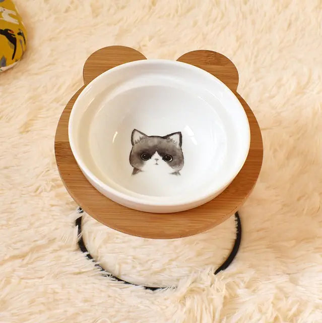 Cat bowl with wooden base on a fluffy surface
