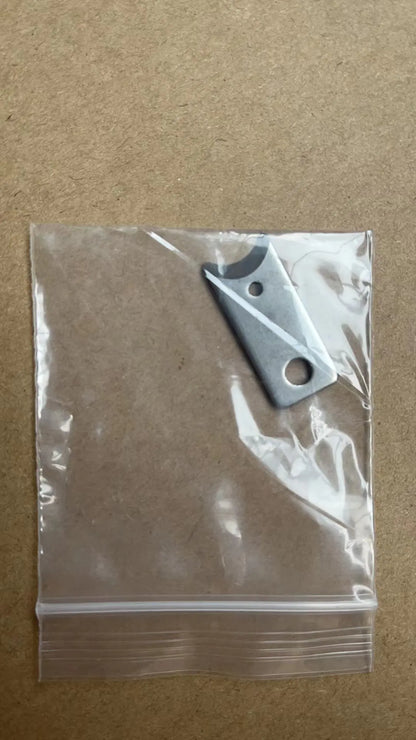 Metal blade in a clear plastic bag on a brown background