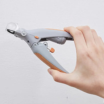 Hand holding a gray and orange tool against a light gray background