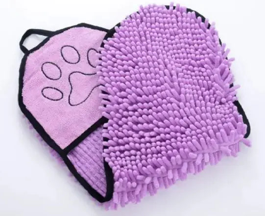 Purple grooming mitt with a paw design on a white background
