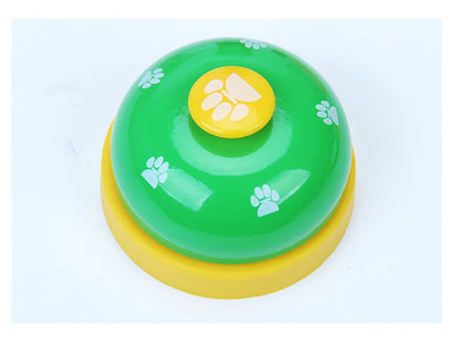 Green and yellow bell with paw prints on a light blue background