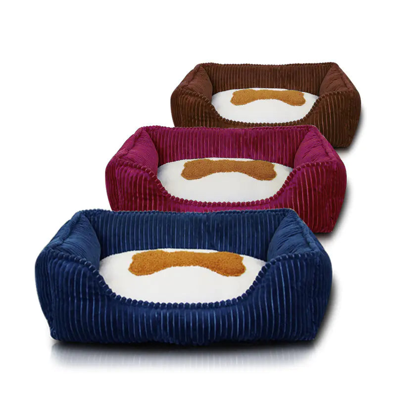 Three corduroy pet beds in blue, red, and brown on a white background
