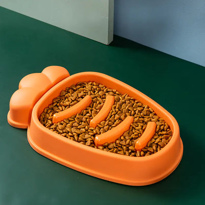 Orange pet food bowl with pet food on a green surface
