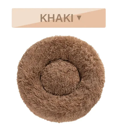Round, fluffy pet bed in khaki color with a label indicating the color on a beige background.
