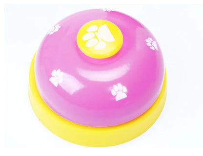 Pink and yellowbell-shaped toy with paw prints and a yellow circle on a white background