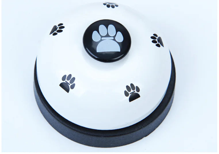 Round white button with black paw print design on a light blue background