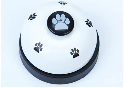 Round white button with black paw print design on a light blue background