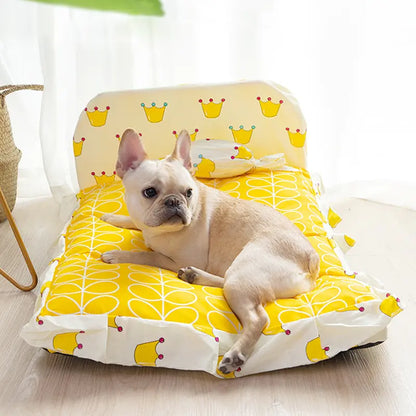 Dog lying on a yellow and white patterned pet bed indoors.