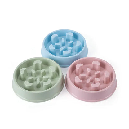 Three colorful silicone pet bowls with textured bottoms on a white background