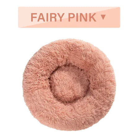 Fluffy pink donut-shaped pet bed with 'Fairy Pink' label above it on a white background