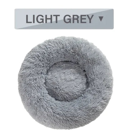 Light gray fluffy pet bed with a label indicating color on a white background