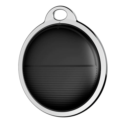 Round metallic object with a black center on a white background