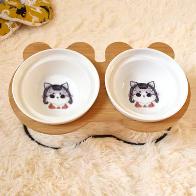 Two white bowls with cartoon dog faces on a wooden stand on a fluffy white surface.