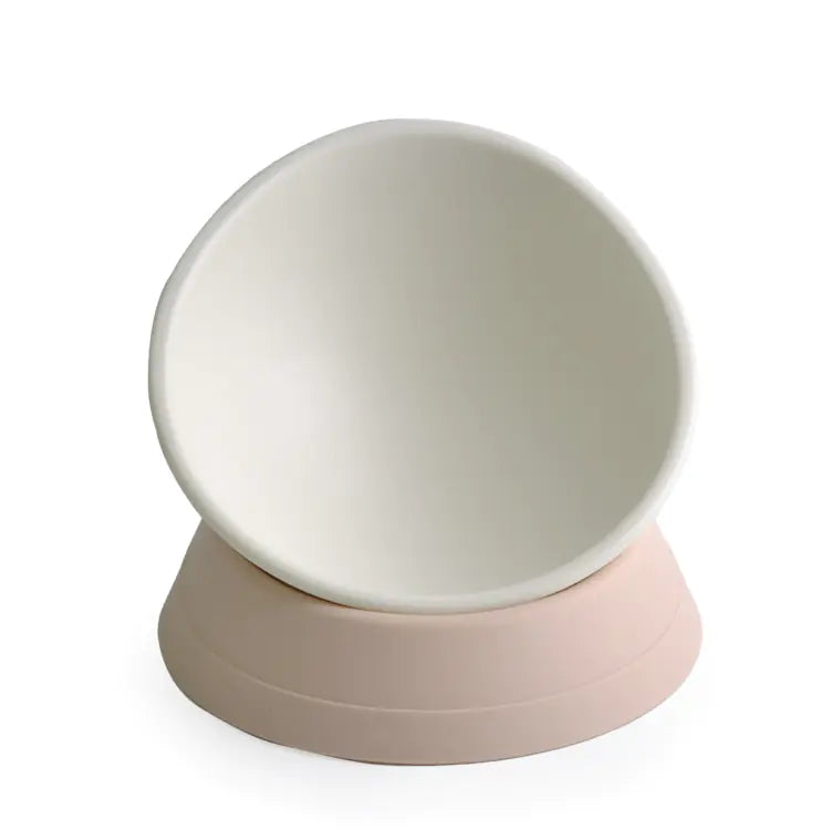 Round beige object with a pink base on a white background