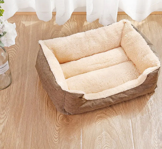 Pet bed with beige cushion on a wooden floor
