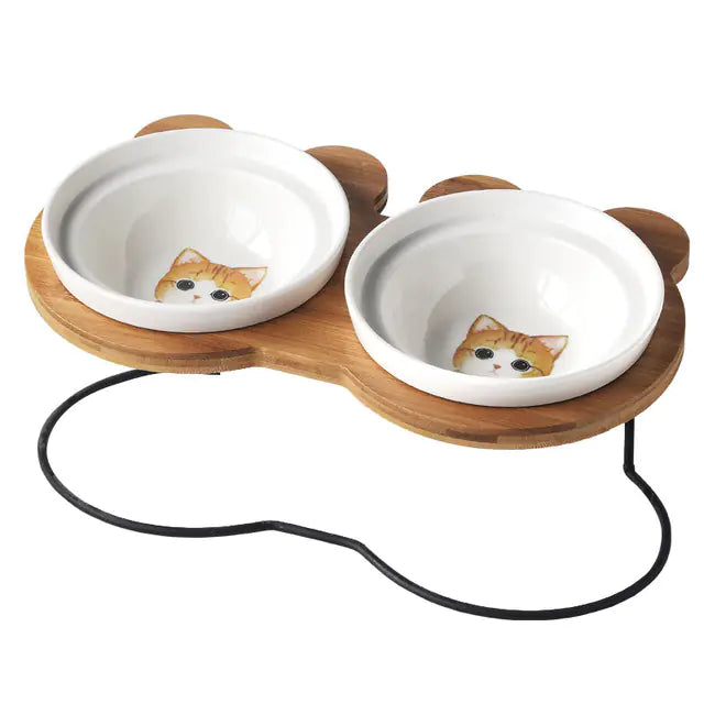 Cat food and water bowls with wooden stand on a white background
