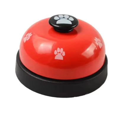 Red bell with black base and paw print design on a white background
