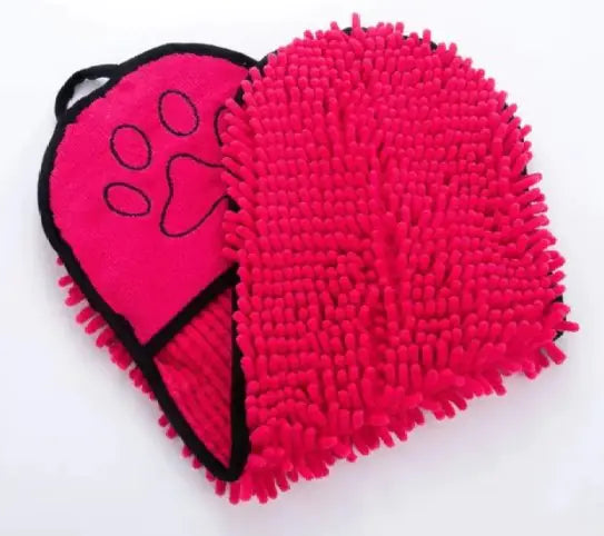 Pink grooming mitt with a paw print design on a white background