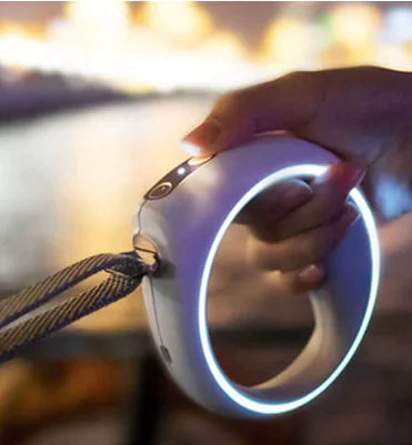 Hand holding a glowing circular device with a blurred background