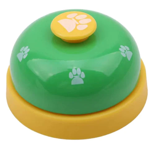 Green and yellow bell-shaped toy with paw prints on a white background