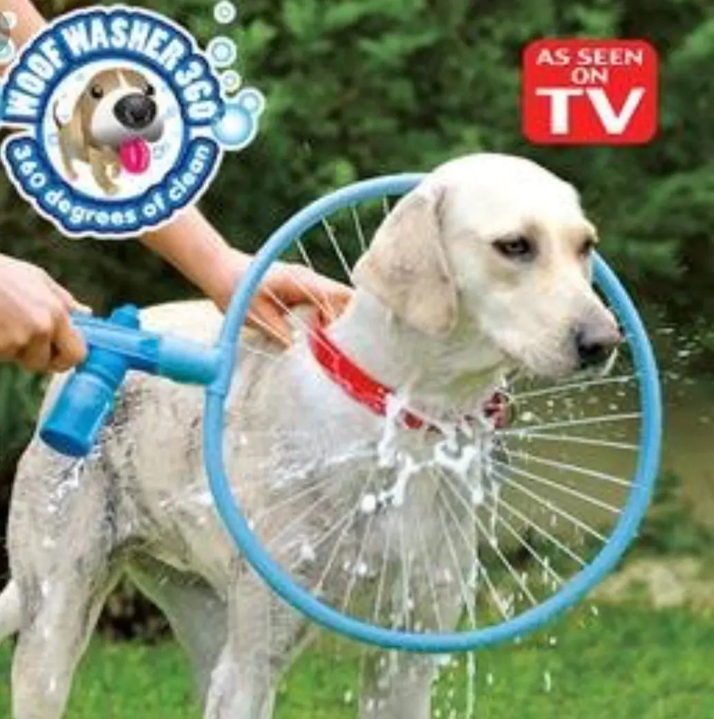 Dog being washed with a hose attachment labeled 'Hood Washer 360' in an outdoor setting.