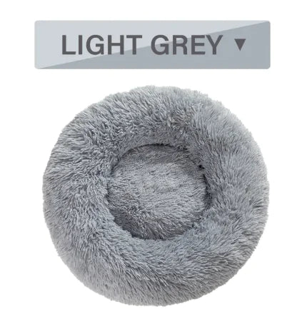 Light gray fluffy pet bed with a label indicating color on a white background